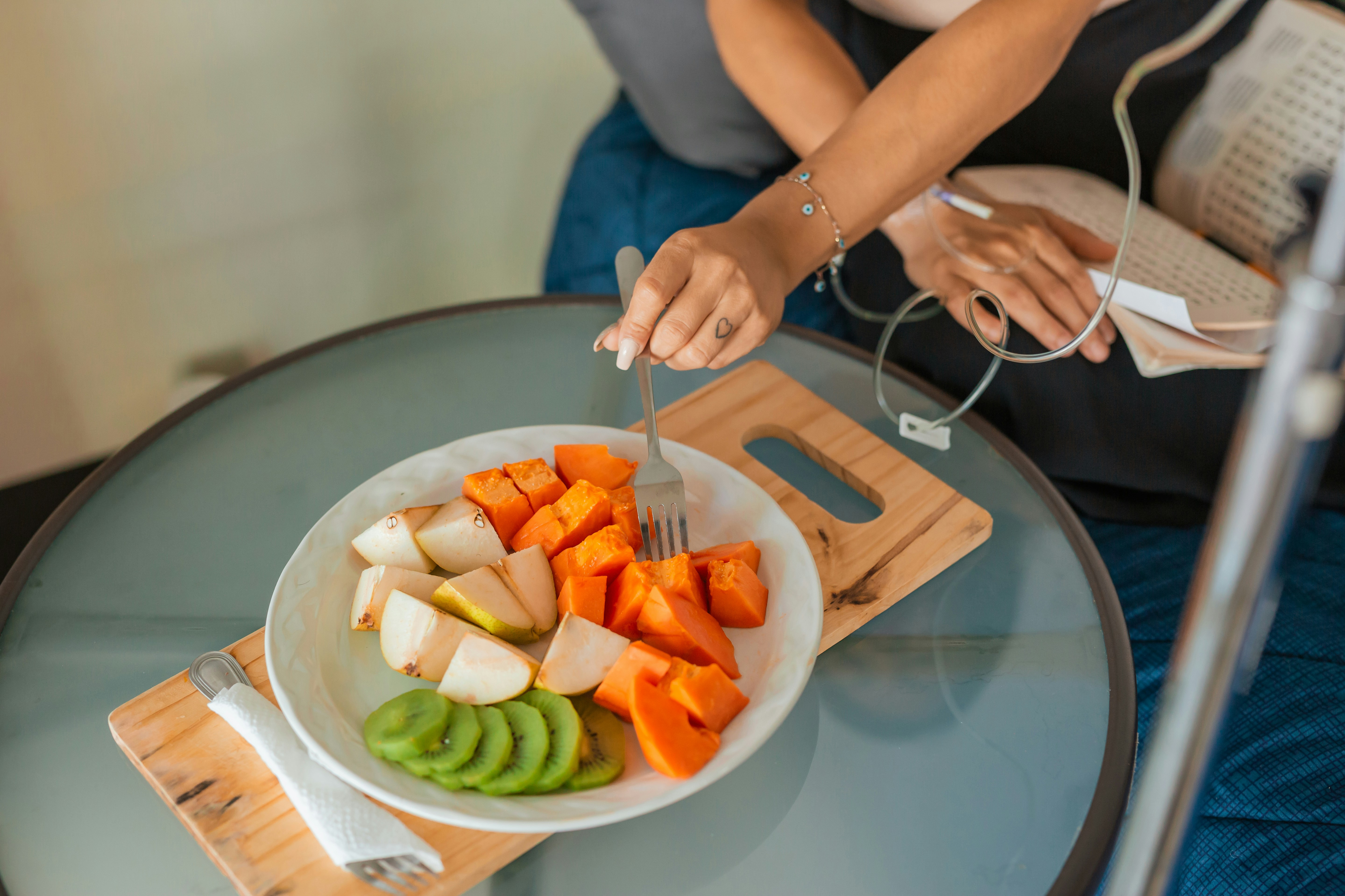 a plate of chopped fruit beside a pair of headphones