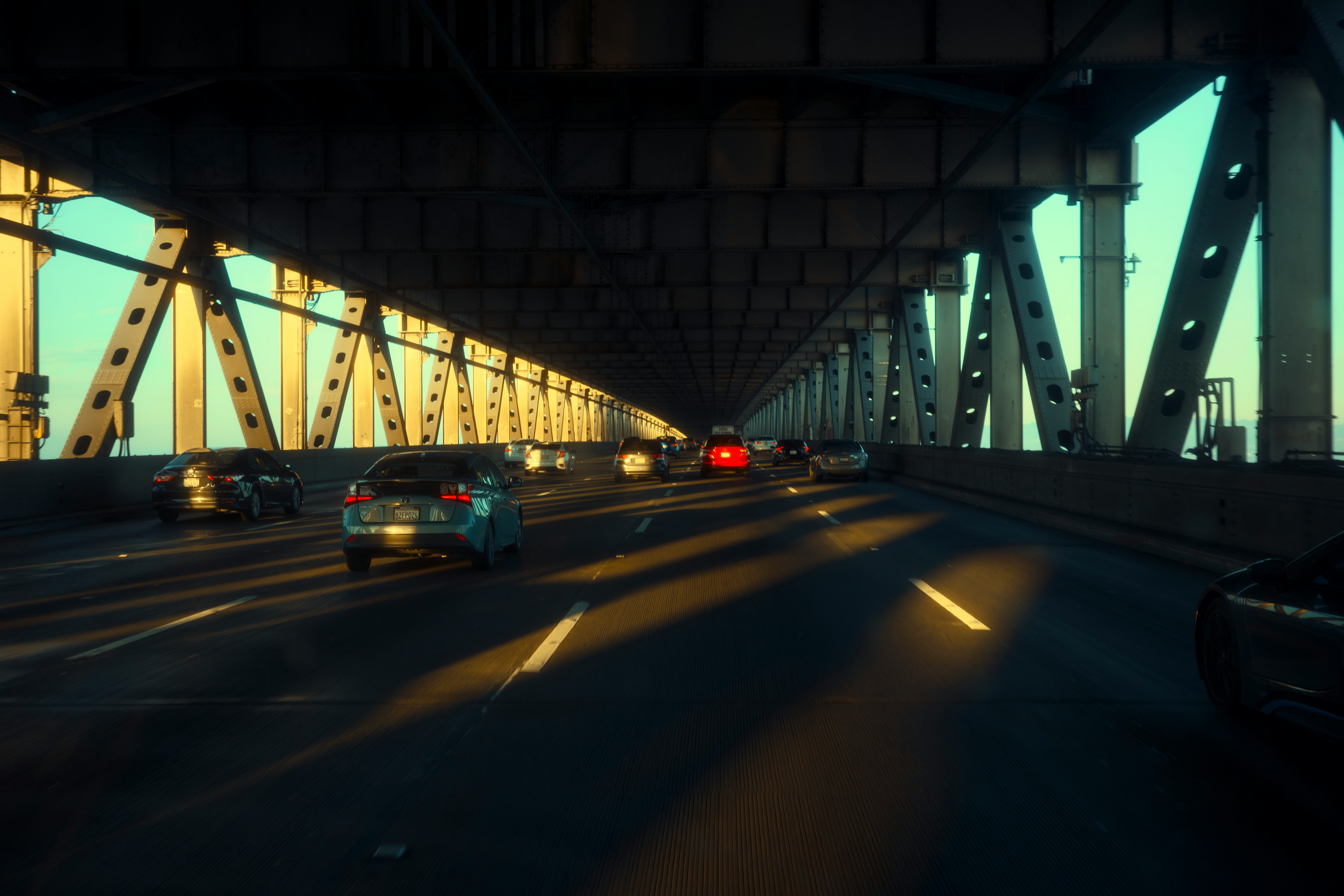 traffic crossing a bridge in low evening light