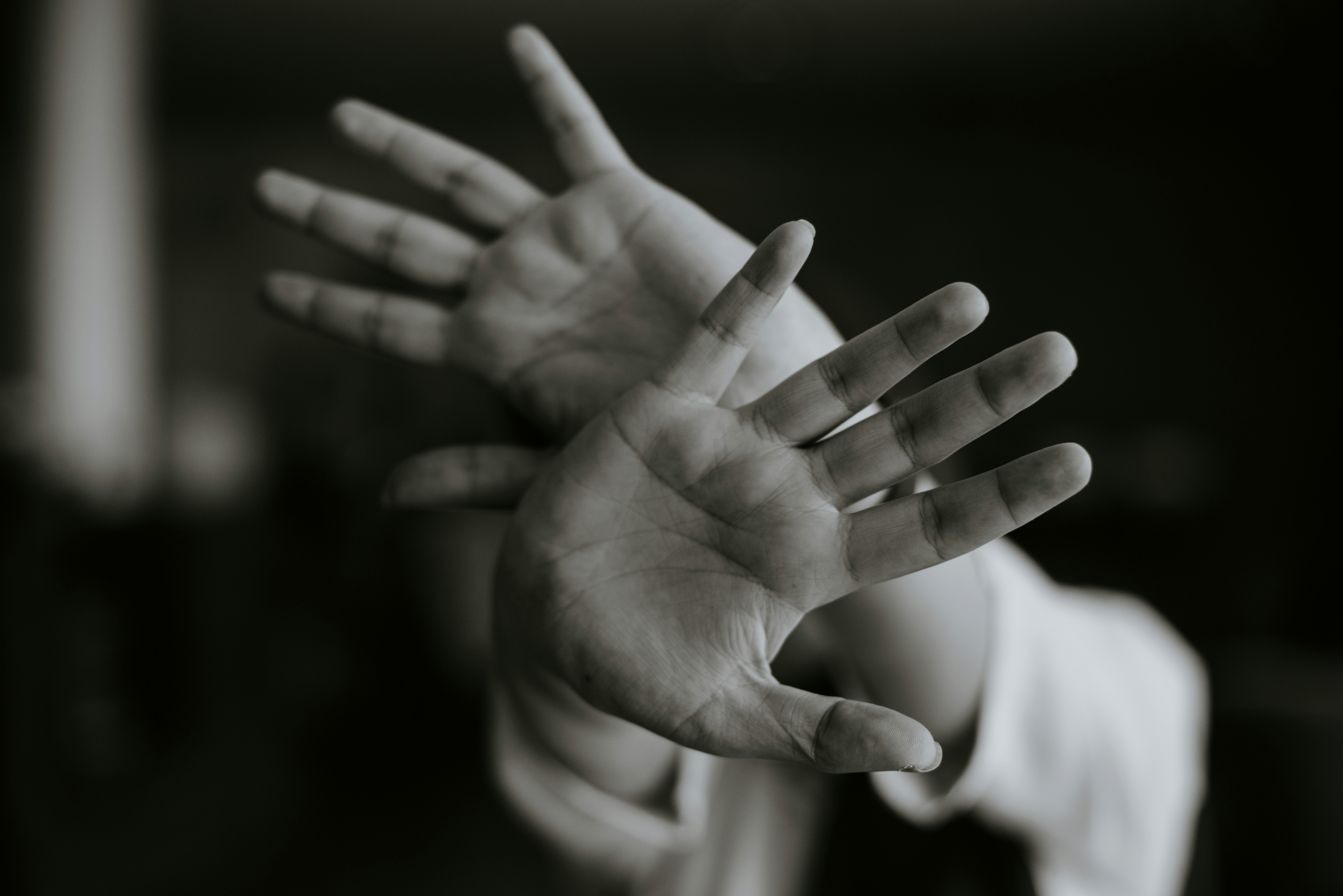 two open hands reaching into the light