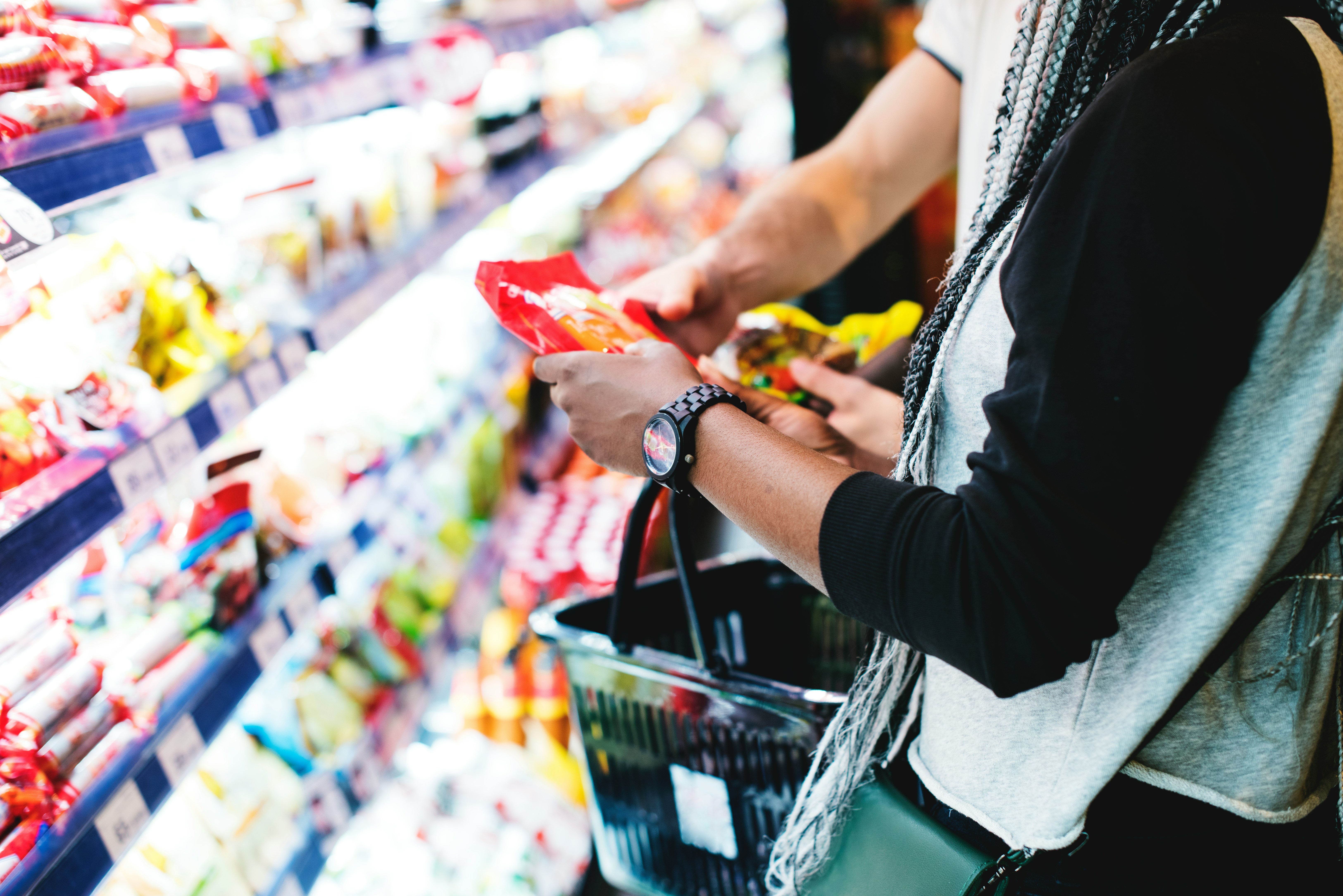 Someone choosing food from a supermarket chiller on an ordinary weekday