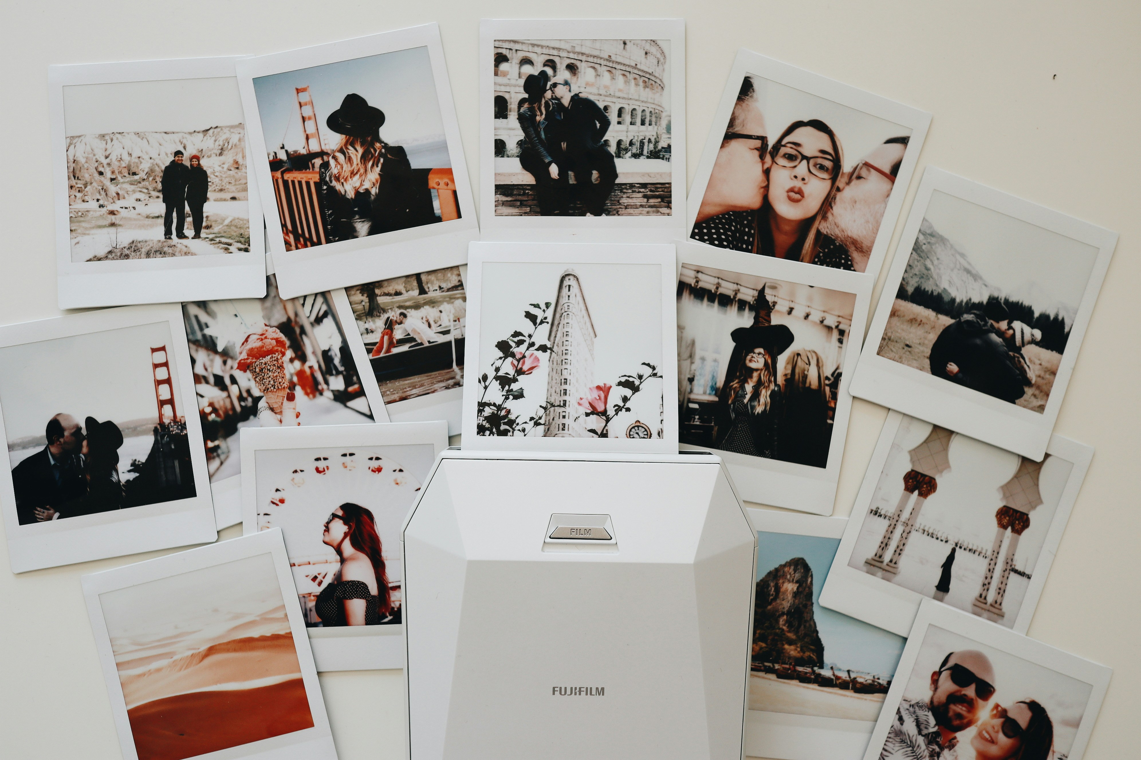 instant photographs spread around a small printer
