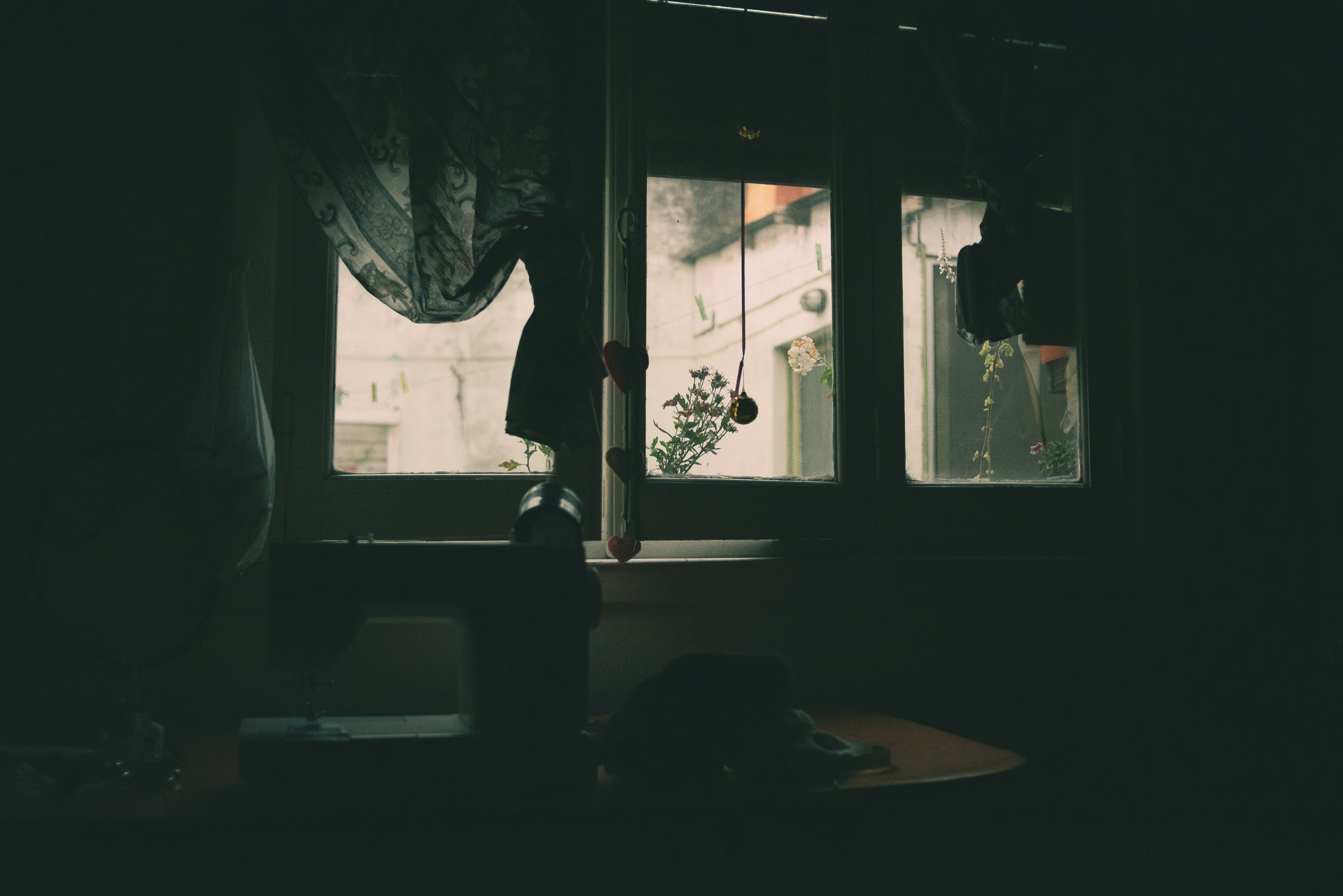 a dark room with light coming through the window