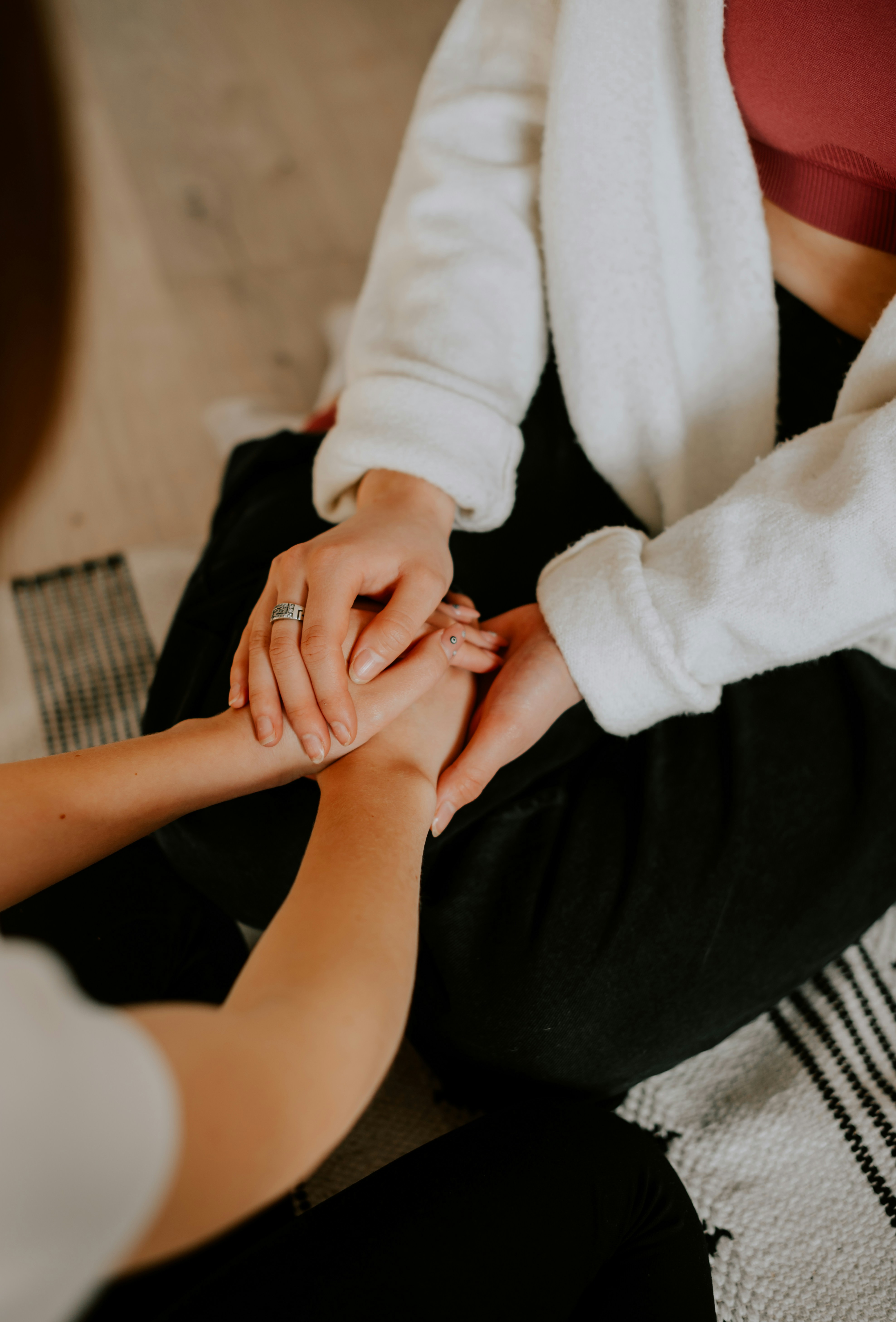 two people holding hands across a table