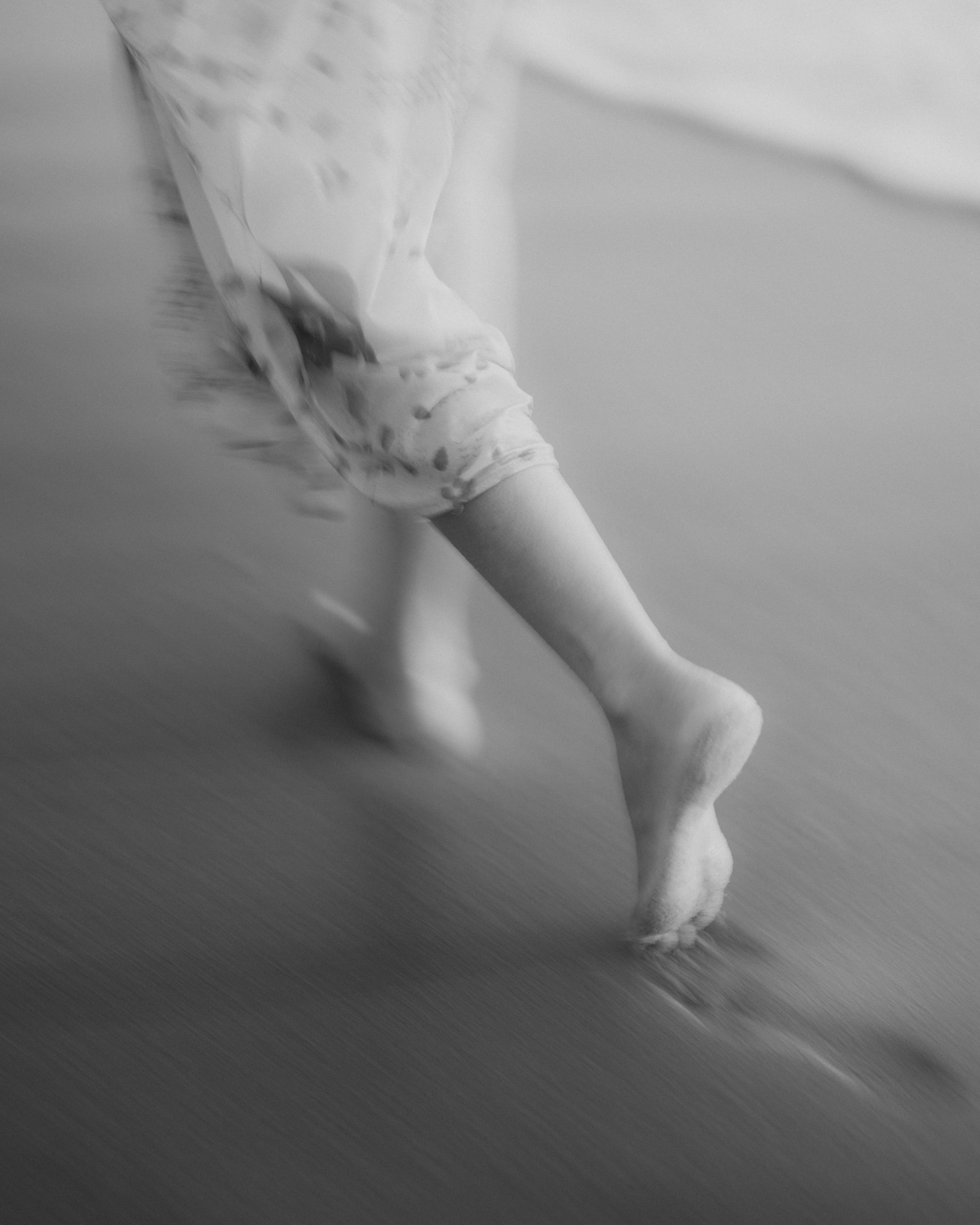 bare feet walking across wet sand