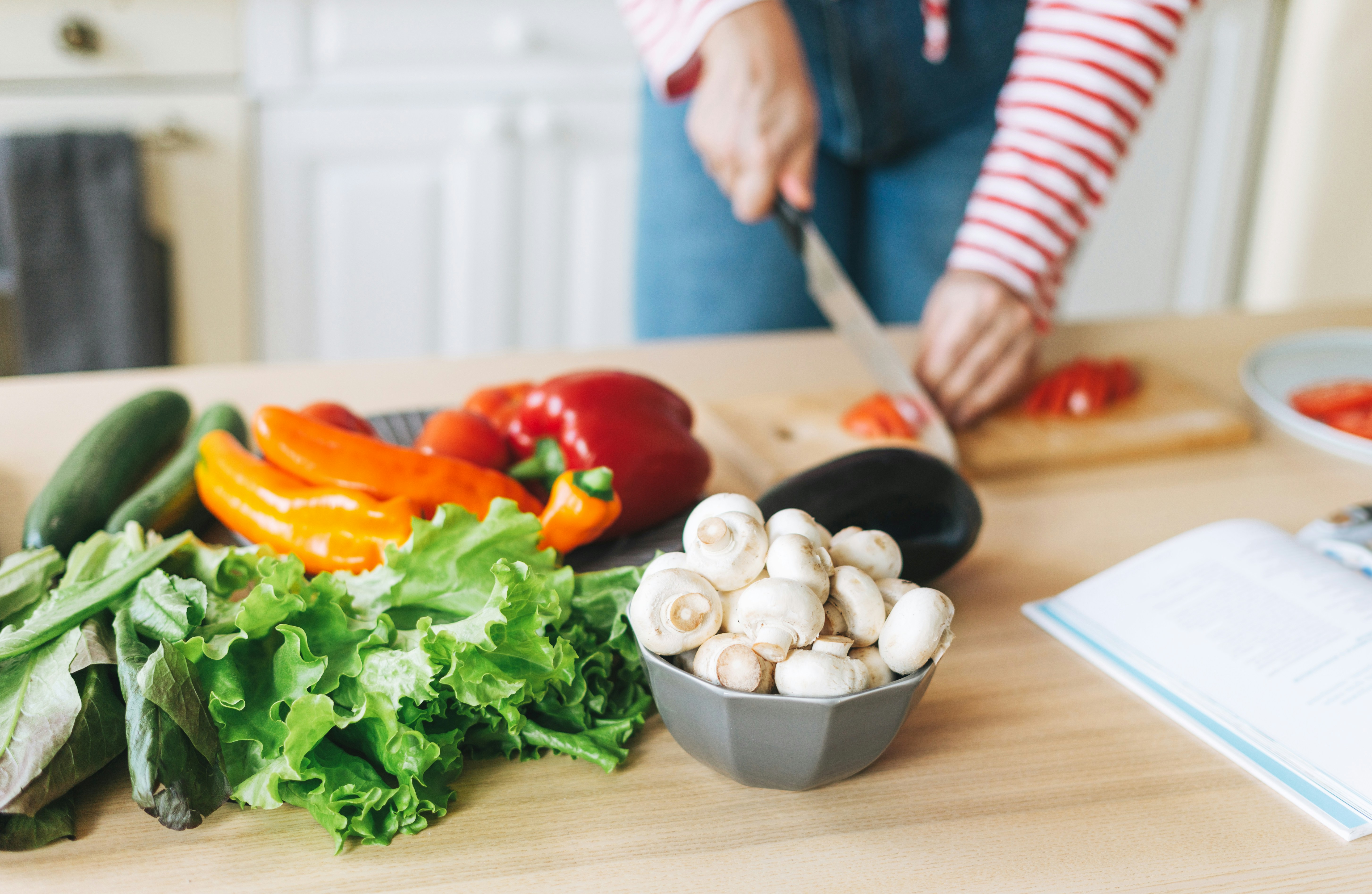 vegetables being chopped on a kitchen counter