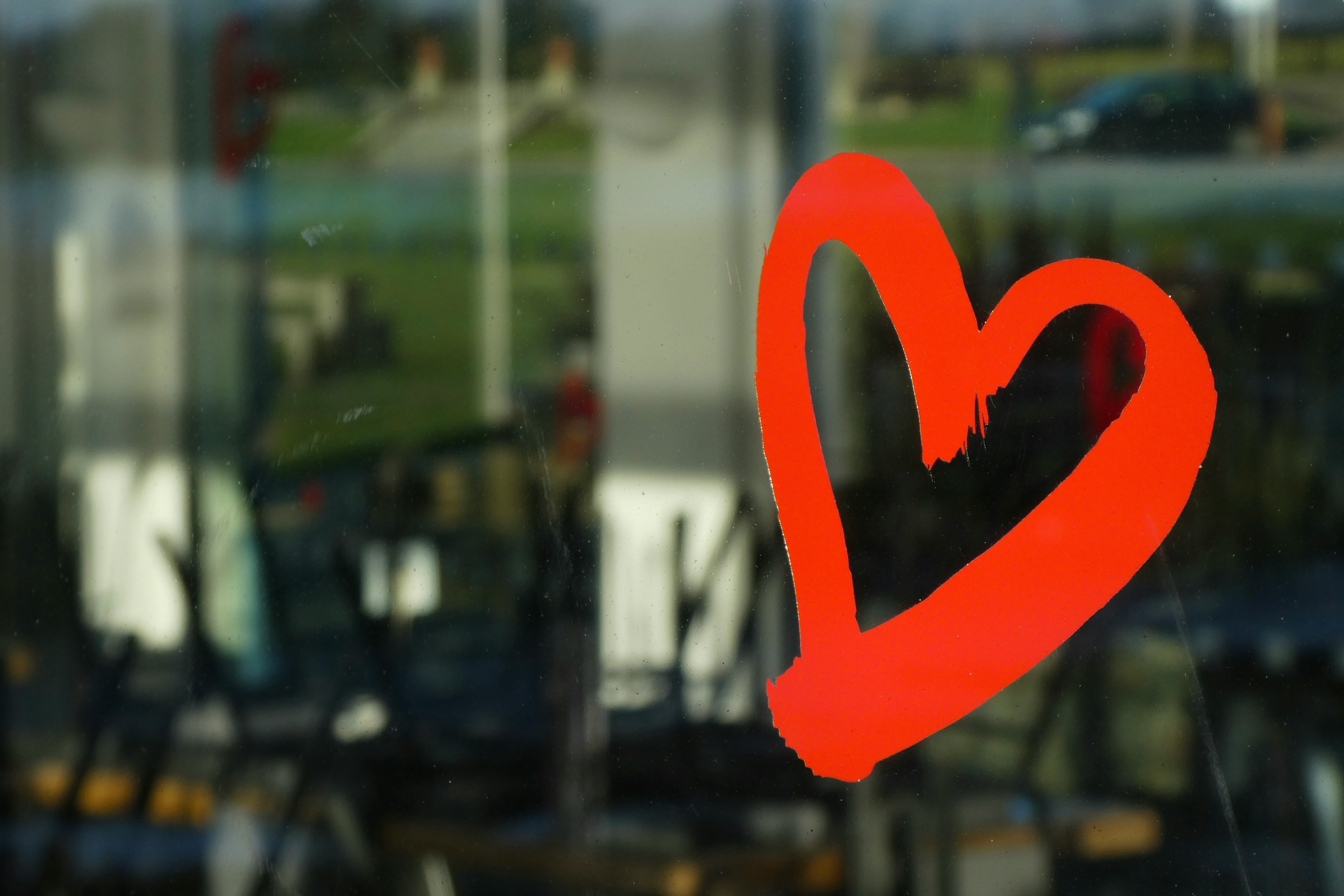 a red heart drawn on a cafe window